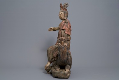 A Chinese polychrome wood group of Guanyin on a dragon, 18th C.