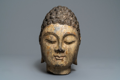 A Chinese carved stone head of Buddha with traces of gilding and polychromy, Ming