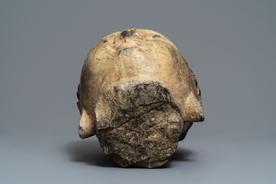 A Chinese carved stone head of Buddha with traces of gilding and polychromy, Ming