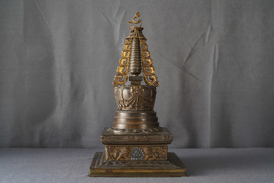 A large parcel-gilt inlaid bronze stupa, Tibet, 18th C.