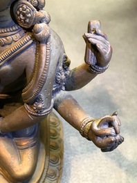 An inlaid gilt bronze figure of Vasudhara, Tibet or Nepal, 18/19th C.