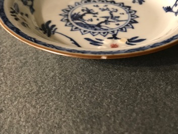 A pair of Chinese blue, white and underglaze red cups and saucers, Kangxi