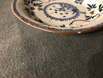 A pair of Chinese blue, white and underglaze red cups and saucers, Kangxi