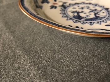 A pair of Chinese blue, white and underglaze red cups and saucers, Kangxi