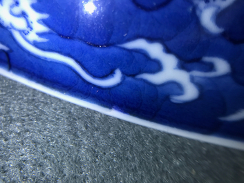 A Chinese blue and white reverse-decorated 'dragon' dish, Daoguang mark and prob. of the period