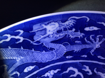 Une assiette en porcelaine de Chine bleu et blanc &agrave; d&eacute;cor invers&eacute; d'un dragon, marque et prob. &eacute;poque de Daoguang