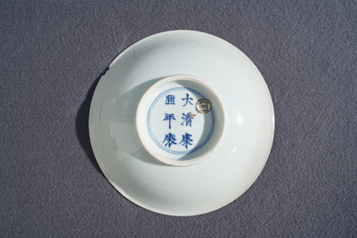 A Chinese blue and white plate with travellers in a landscape, Kangxi mark and of the period