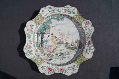 A large Chinese Canton enamel charger with figures in a garden, Yongzheng
