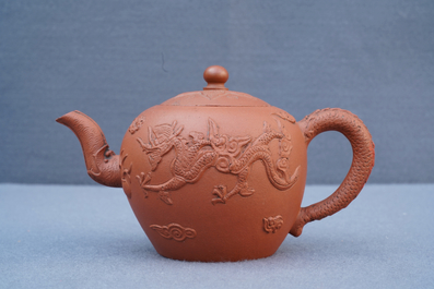 A Chinese Yixing stoneware teapot with applied dragons, Kangxi