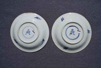 A pair of Chinese blue, white and underglaze red cups and saucers, Kangxi
