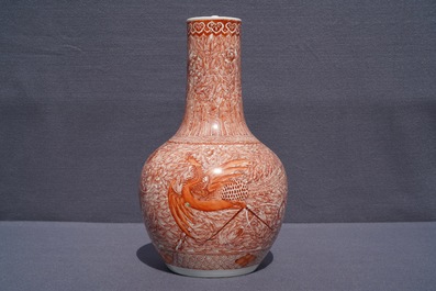 A Chinese iron red 'dragon and phoenix' bottle vase, 19th C.