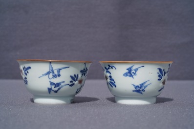 A pair of Chinese blue, white and underglaze red cups and saucers, Kangxi