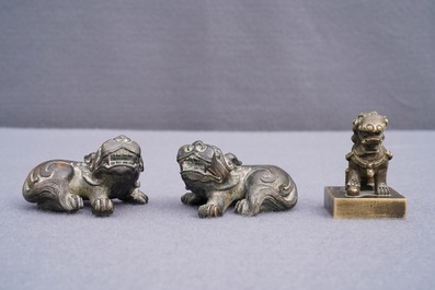 A pair of Chinese bronze 'lion' scroll weights and a seal, Ming and 18th C.