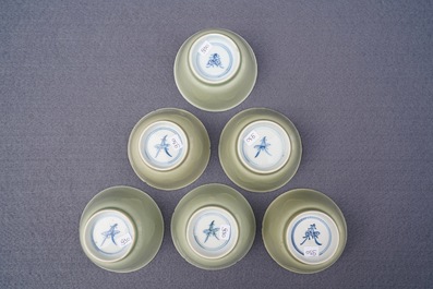 Six Chinese celadon and blue and white 'crabs and fish' cups and saucers, Kangxi