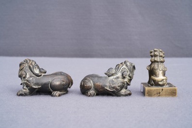 A pair of Chinese bronze 'lion' scroll weights and a seal, Ming and 18th C.