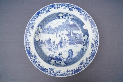 A deep Chinese blue and white dish with figures in a garden, Yongzheng