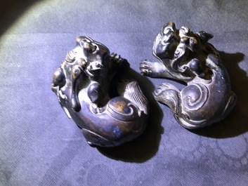 A pair of Chinese bronze 'lion' scroll weights and a seal, Ming and 18th C.