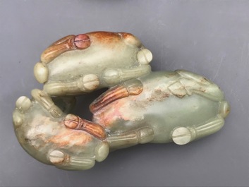 A Chinese pale celadon and russet jade 'three rams' group on carved wooden stand, 18/19th C.