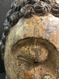 A Chinese carved stone head of Buddha with traces of gilding and polychromy, Ming