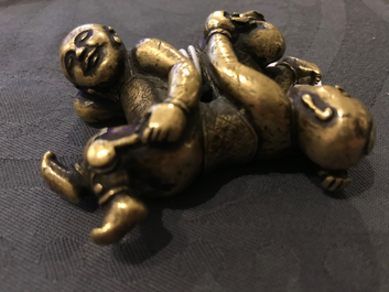 A Chinese gilt bronze Hoho brothers scroll weight, 18/19th C.