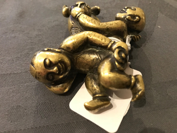 A Chinese gilt bronze Hoho brothers scroll weight, 18/19th C.