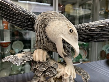 A Chinese carved ivory model of an eagle with a snake, ca. 1930