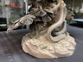 A Chinese carved ivory model of an eagle with a snake, ca. 1930