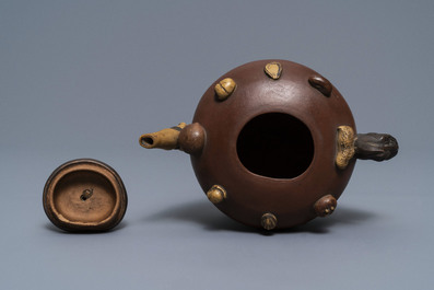 A Chinese Yixing stoneware relief-decorated teapot with nuts and fruits, Shao Er Quan mark, Daoguang