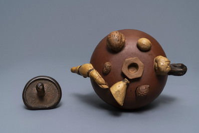 A Chinese Yixing stoneware relief-decorated teapot with nuts and fruits, Shao Er Quan mark, Daoguang