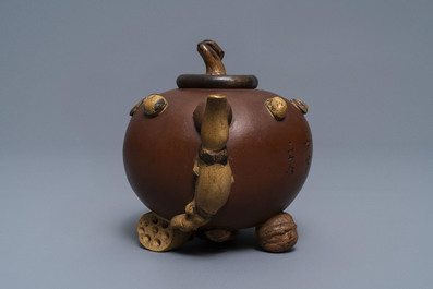 A Chinese Yixing stoneware relief-decorated teapot with nuts and fruits, Shao Er Quan mark, Daoguang