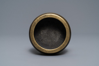 A flat Chinese bronze tripod censer, Xuande mark, 18th C.