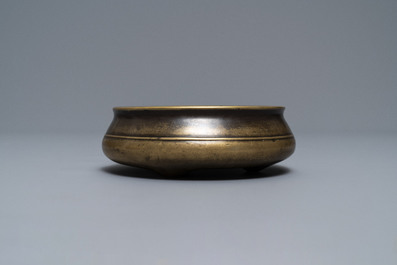 A flat Chinese bronze tripod censer, Xuande mark, 18th C.