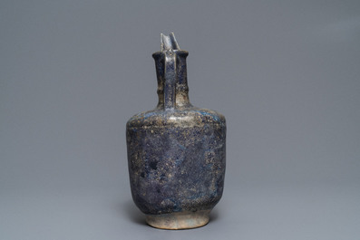 A blue-glazed Islamic pottery jug, Kashan, Iran, 13th C.