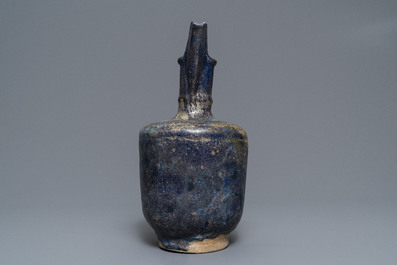 A blue-glazed Islamic pottery jug, Kashan, Iran, 13th C.