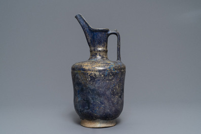 A blue-glazed Islamic pottery jug, Kashan, Iran, 13th C.