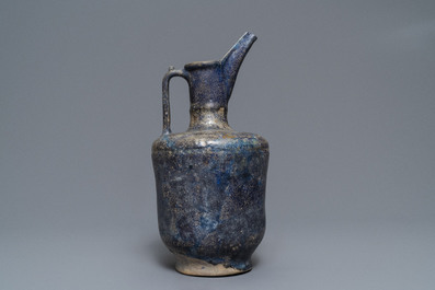 A blue-glazed Islamic pottery jug, Kashan, Iran, 13th C.