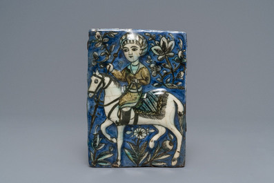 Three Qajar relief-moulded tiles with soldiers on horseback, Iran, 19th C.