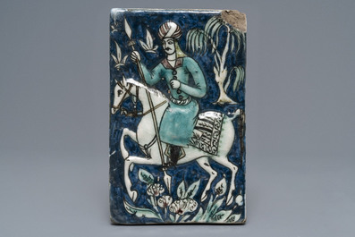 Three Qajar relief-moulded tiles with soldiers on horseback, Iran, 19th C.