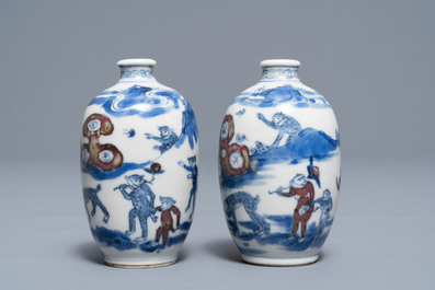 A pair of Chinese blue, white and underglaze red '16 monkeys' snuff bottles, Yongzheng mark, 19th C.