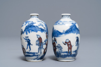 A pair of Chinese blue, white and underglaze red '16 monkeys' snuff bottles, Yongzheng mark, 19th C.