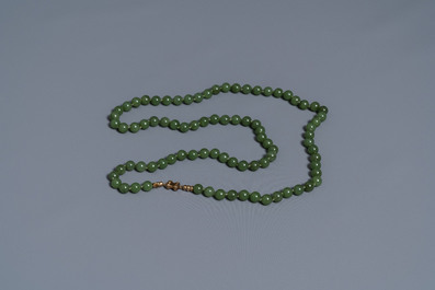 Two Chinese necklaces and a bracelet with spinach green jade beads, 20th C.