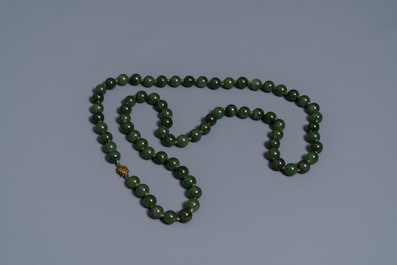 Two Chinese necklaces and a bracelet with spinach green jade beads, 20th C.