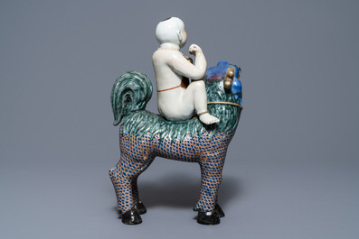 A Chinese famille rose figure of Buddha and a famille rose boy on qilin, 19th C.