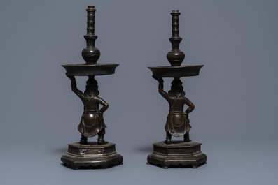 A pair of Chinese bronze candlesticks, Ming