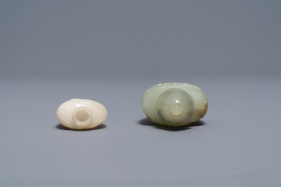 Two Chinese Mughal-style white and celadon jade snuff bottles, 19th C.