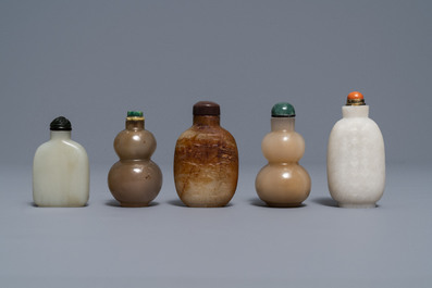 Five Chinese celadon and russet jade snuff bottles, 19/20th C.
