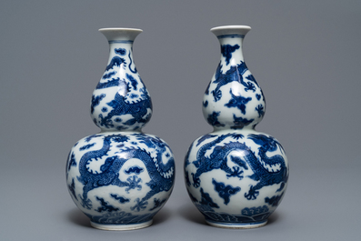 A pair of Chinese blue and white double gourd 'dragon' vases, Qianlong mark, 19th C.