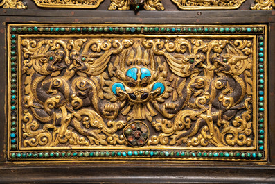 A turquoise-inlaid gilt bronze and copper repouss&eacute; 'tepchog' folding altar table, Tibet, 19th C.