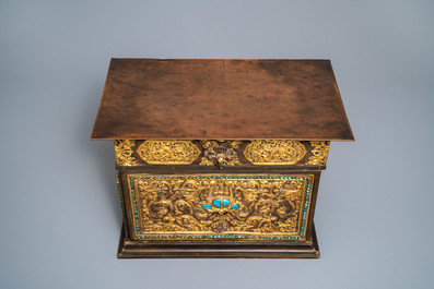 A turquoise-inlaid gilt bronze and copper repouss&eacute; 'tepchog' folding altar table, Tibet, 19th C.