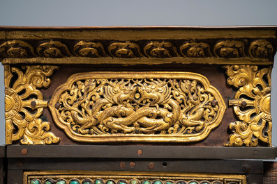 A turquoise-inlaid gilt bronze and copper repouss&eacute; 'tepchog' folding altar table, Tibet, 19th C.